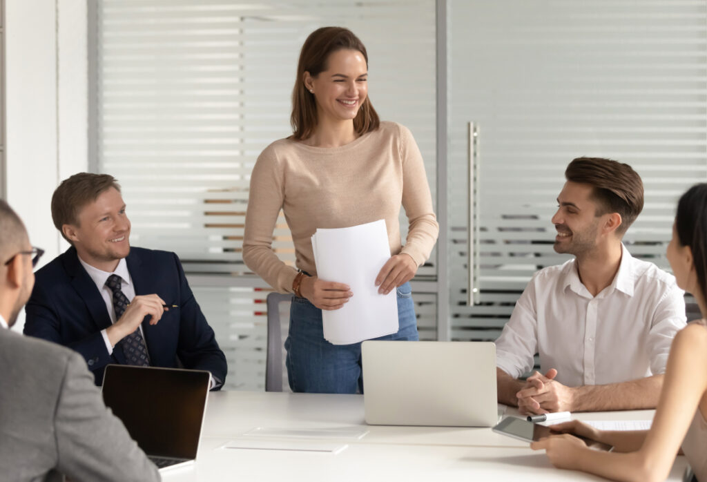 Business meeting with happy employees discussing projects in a modern office.