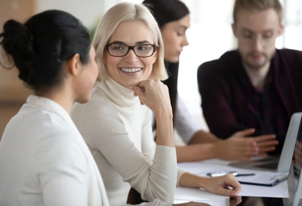 Colleagues engage in a supportive and collaborative office discussion.