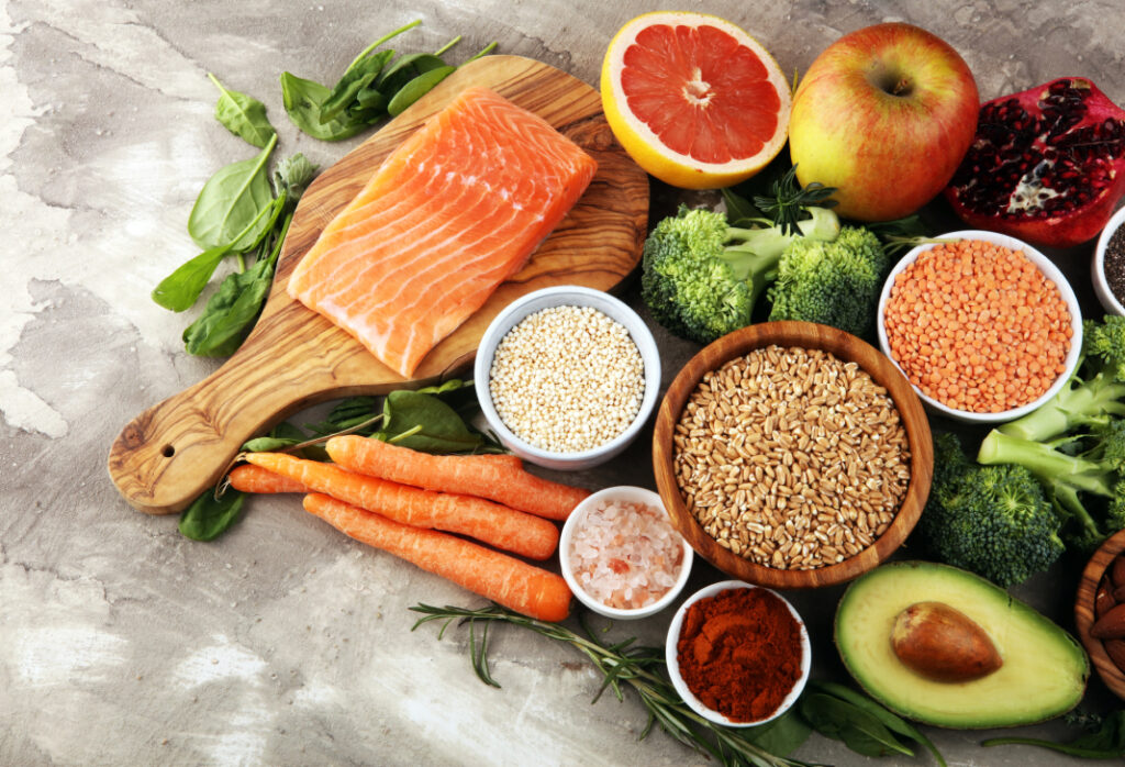 Healthy and balanced meal ingredients arranged on a rustic wooden surface.