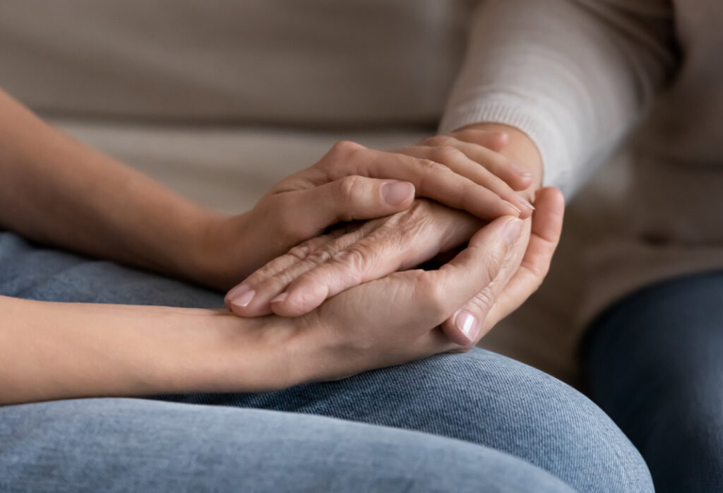 Supportive hands offering comfort and understanding in a caring environment.