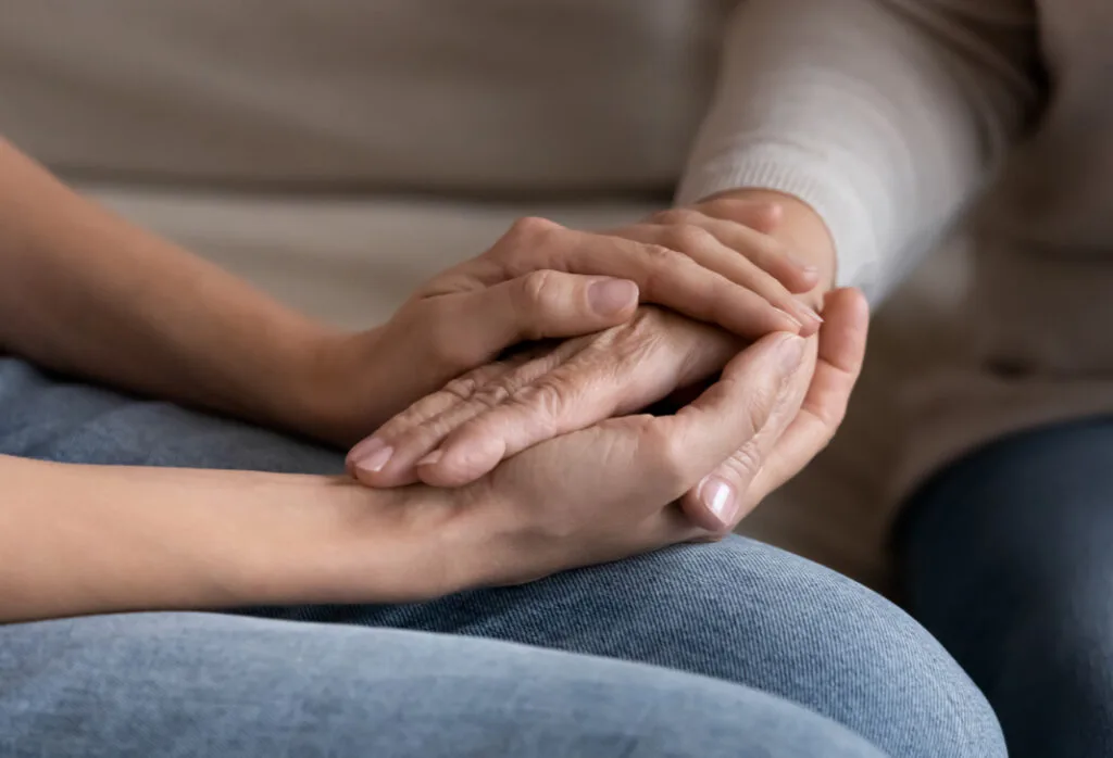 Supportive hands offering comfort and understanding in a caring environment.