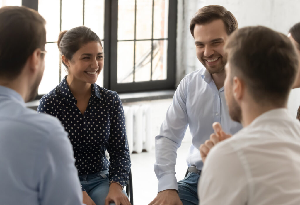 People having a supportive discussion in a workplace setting.