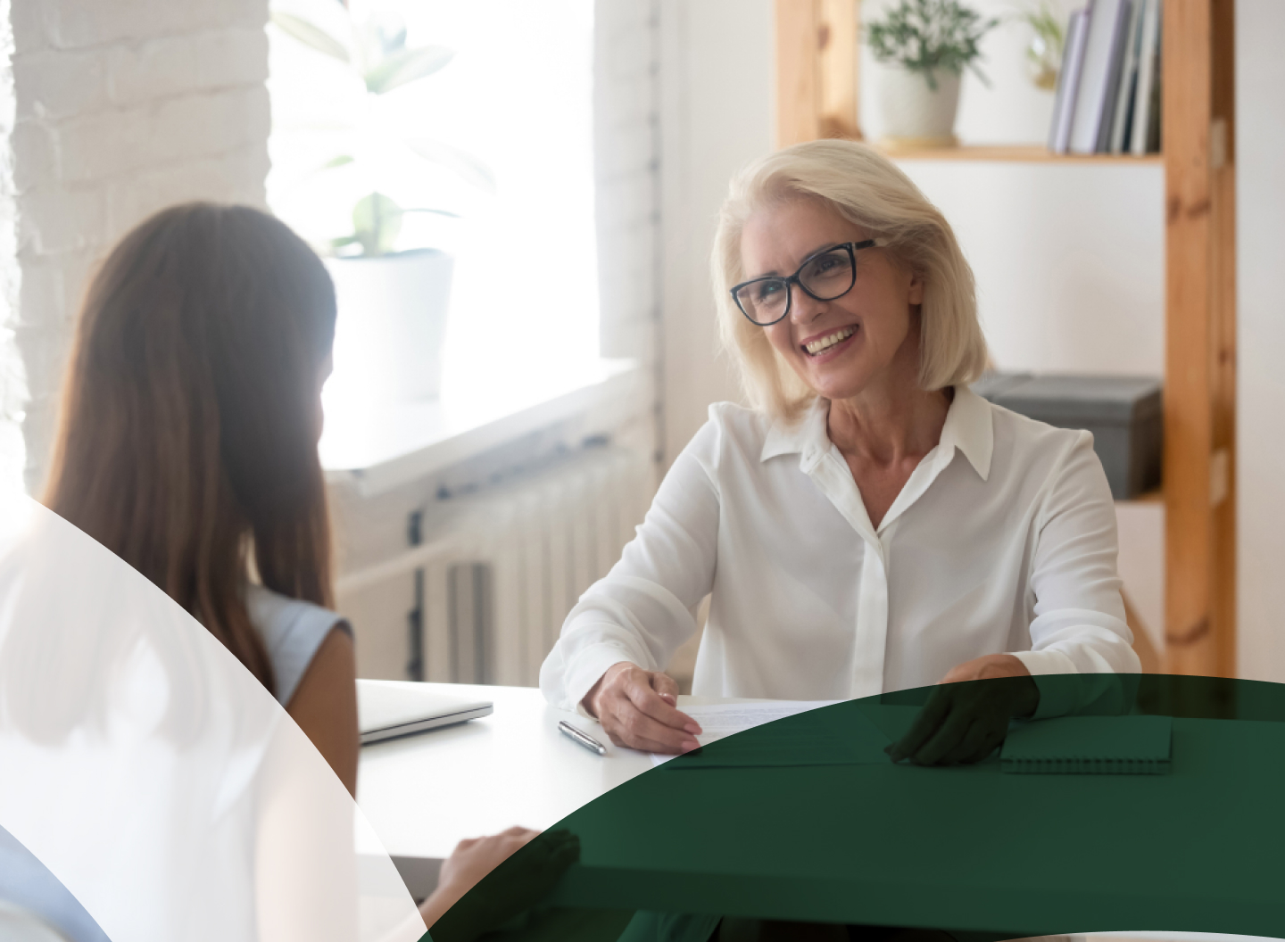 Businesswoman smiling during a consultation in a bright office setting.