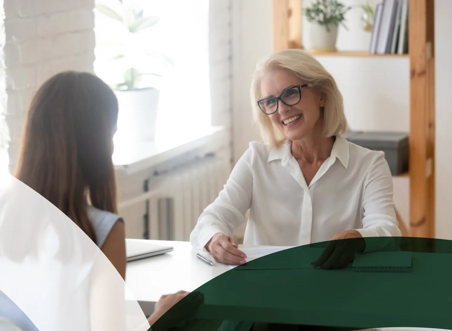 Businesswoman smiling during a consultation in a bright office setting.