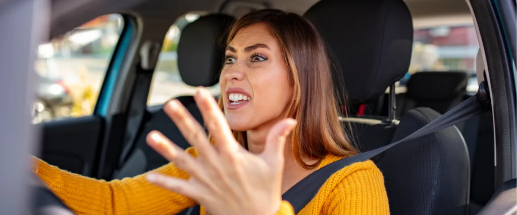 Frustrated woman driving experiencing stress needing assistance and support.