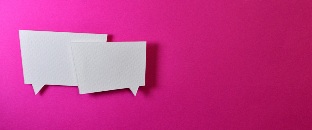 Two blank chat bubbles resting on a vibrant pink background.